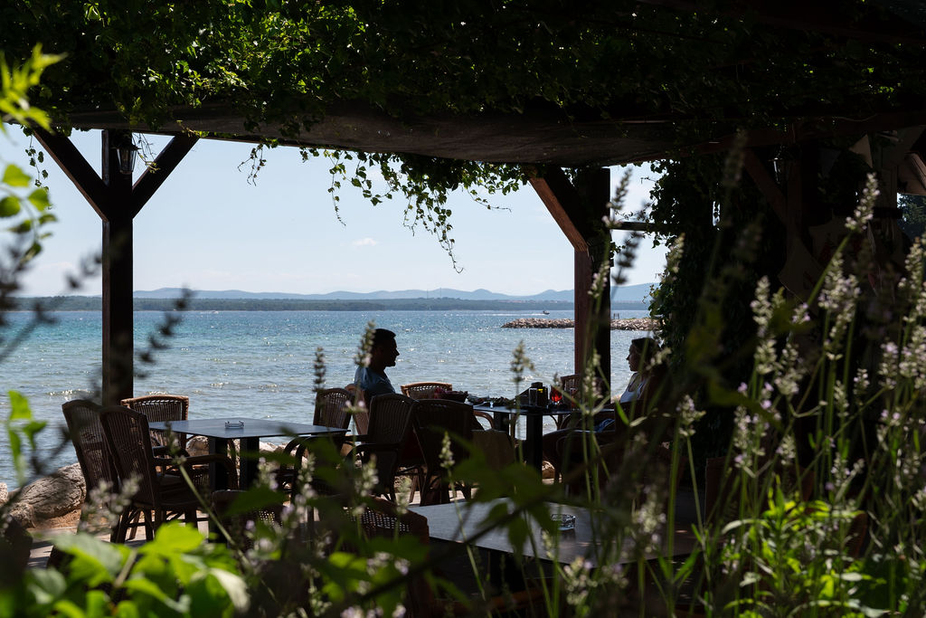 Family dining by the beach in Tkon